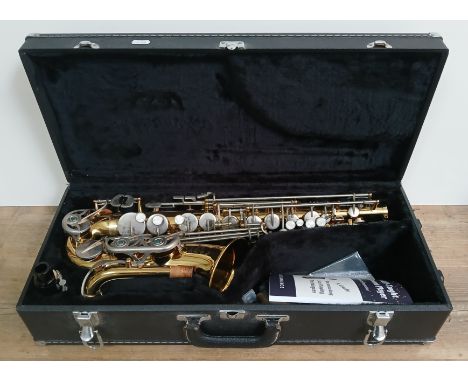 An Earlham alto saxophone in hard case, with book and accessories. Condition- appears to be good, no signs of any damage or o