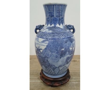 A Chinese blue and white porcelain vase, bearing six character seal to base, 20th century, with carved wood stand, height 34c
