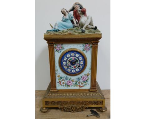 A French gilt brass and porcelain mantle clock, circa 1900, figural top signed 'TYCHE', height 49cm. Condition- clock is unte