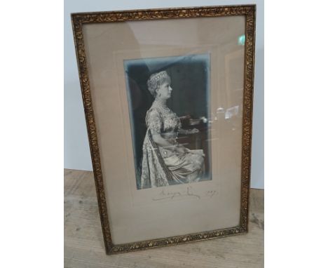 Queen Mary, a 3/4 length photographic portrait depicting queen seated, signed and dated 1927 in the margin, glazed and framed