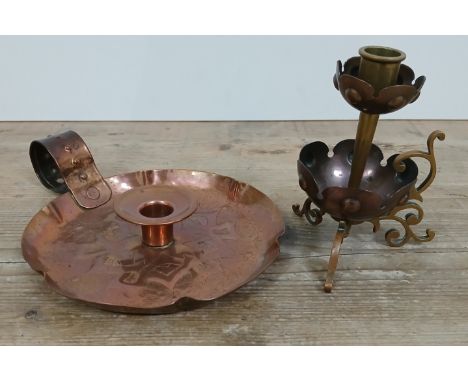 An Arts &amp; Crafts copper and brass chamber stick in the manner of WAS Benson, height 13cm, and another embossed copper cha