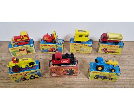 Seven boxed Matchbox diecast models comprising of rod roller 21, steam locomotive 43, grit speader 70, ford tractor 39, case 