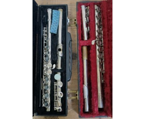 A Boosey &amp; Hawkes flute and a CCM flute, both with cases.