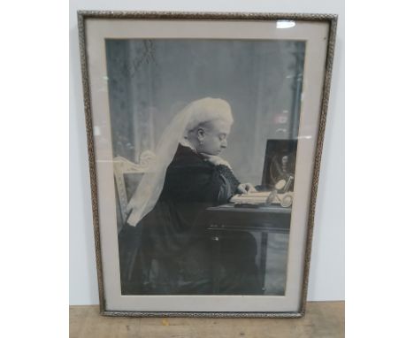 Queen Victoria, autographed photographic portrait depicting the queen seated at desk, signed and dated 1893, glazed, later fr