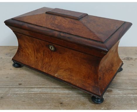 A mid 19th century burr yew wood and rose wood tea caddy of waisted sarcophagus form, with cut glass mixing bowl and interior
