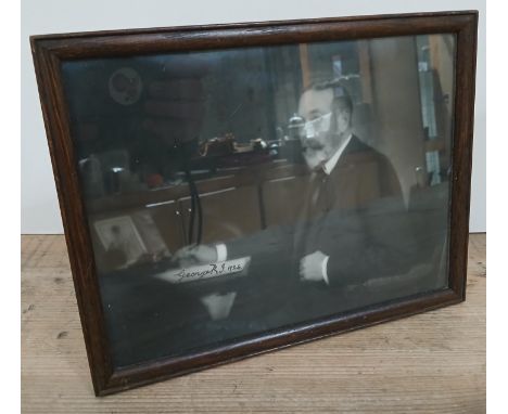 King George V, an autographed photographic portrait depicting the king seated at desk, glazed and framed 26cm x 20cm.