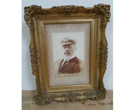 Kind Edward VII, a photographic portrait depicting the King in Naval uniform, mounted on board, signed to margin, glazed and 