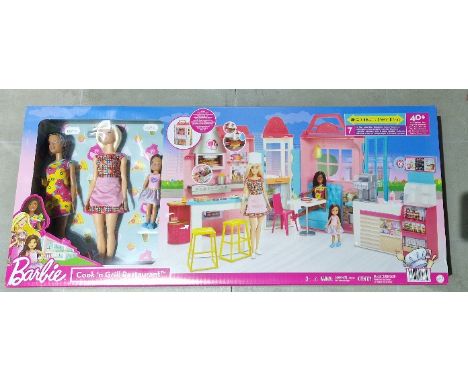 A boxed Barbie Cook and Grill Restaurant set including three dolls. 