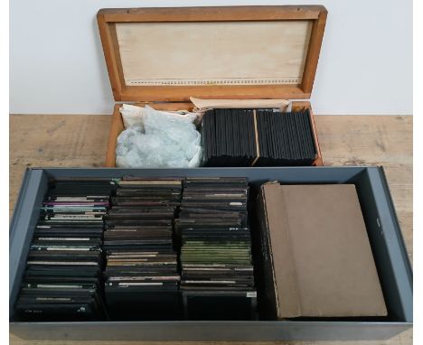 A metal tray and a wooden box of assorted magic lantern slides. 