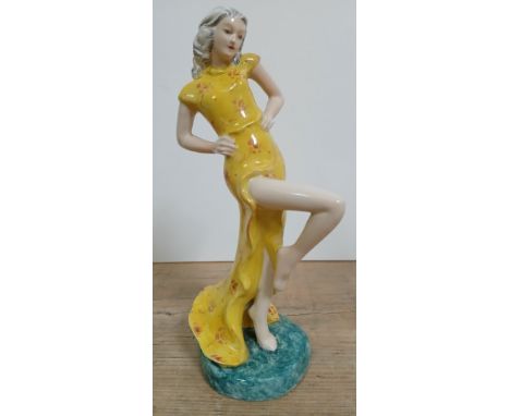 A Goldscheider Art Deco figurine modelled as a lady in yellow dress, height 18cm.&nbsp;Condition - no chips, cracks nor any s