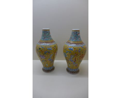 A pair of late 19th century Chinese vases decorated with Shou characters, Phoenix and Peony on a yellow ground, seal mark Dao