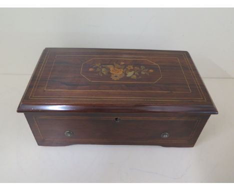 A good quality Victorian marquetry inlaid music box by A Bremond, serial number 1246, playing 4 airs with 6 inch brass cylind