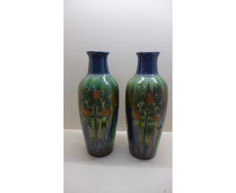 A pair of English art deco ceramic vases decorated with orange trees, 42cm tall, generally good condition overall crazing and