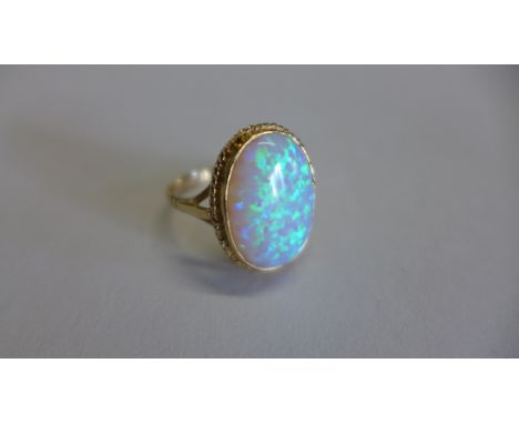 A hallmarked 9ct yellow gold opal ring, size R, approx 3.3 grams, in good condition 