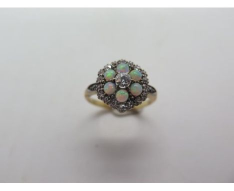 An 18ct yellow gold diamond and opal cluster ring, head approx 12mm diameter, ring size M, approx 4 grams, in good condition,