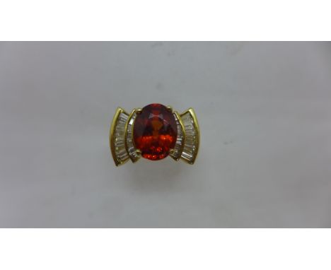 A 14ct Mandarin Garnet and diamond ring, the garnet approx 11 x 8.5 x 5.5mm, ring size O, approx 8.8gs marked 14k, in good co