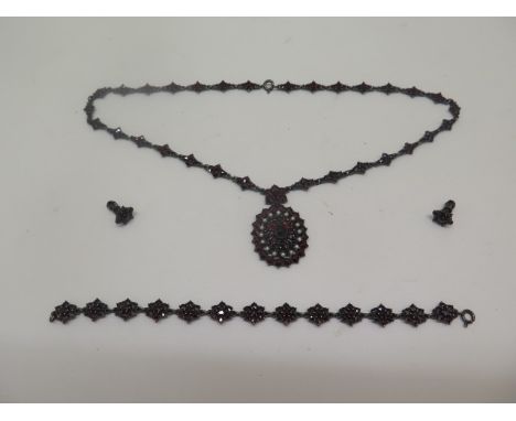 A bohemian white metal garnet and pearl necklace with bracelet and earrings. all generally good condition, bracelet 18cm long