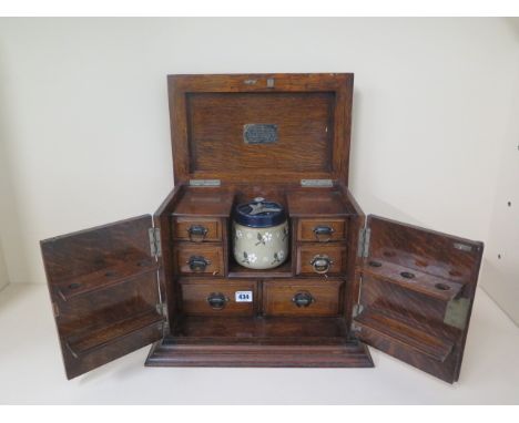 Of railway interest, an oak presentation pipe smokers cabinet from friends at L.M.S dated 1928, 31cm tall, 37 x 23cm 