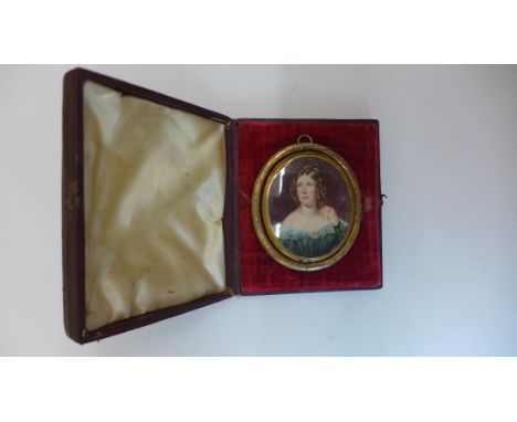 A Victorian gilt metal reversible mourning pendant brooch with a portrait and hair locks, the case engraved Eleanor Eaton die