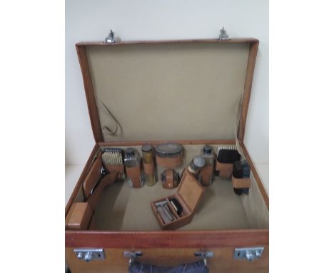 A vintage light tan pig skin leather fitted suitcase with silver top bottles hallmarked London 1942/43. 20cm tall, 51 x 36cm 