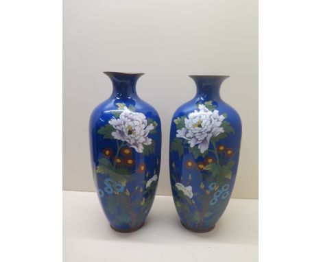 A pair of early 20th century hexagonal cloisonne vases decorated with peony and chrysanthemum on a blue ground. Height 31 cm.