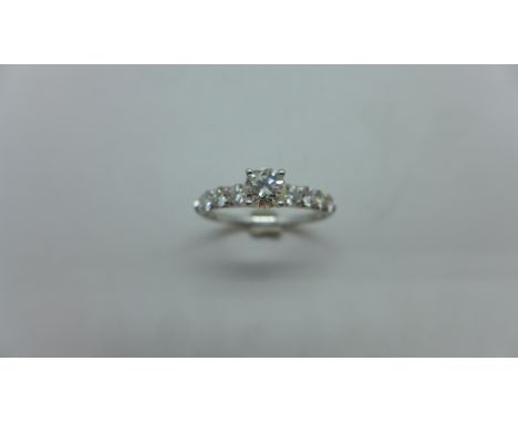 An 18ct white gold 9 stone diamond ring - 1ct of diamonds in total - diamond weight marked to inside of   the shank - centre 