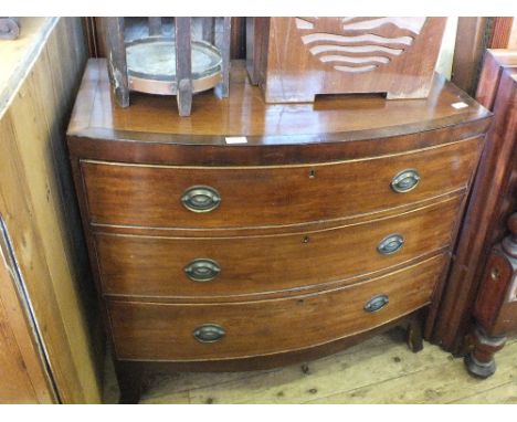 A 19th Century Mahogany and cross banded bow front chest of three drawers on bracket feet and stick stand