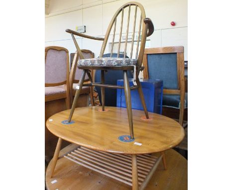 Two Ercol stickback elbow chairs and circular coffee table with under tier