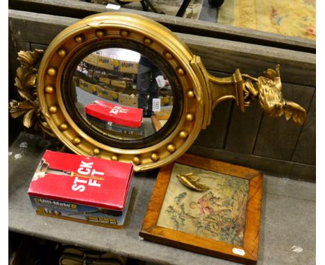A 19th century gilt and gesso convex wall mirror, surmounted by an eagle, re-painted; together with a tapestry fragment, bird
