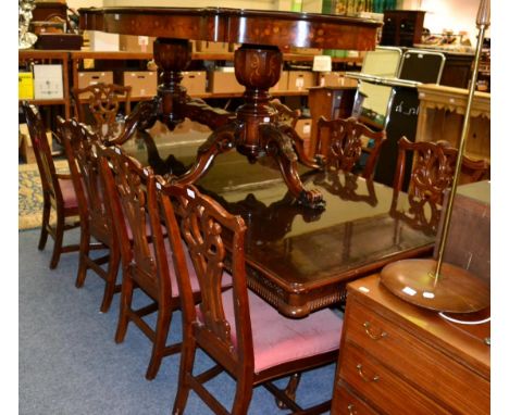Reproduction twin-pedestal dining table with two additional leaves; a set of eight Chippendale style dining chairs; and an It