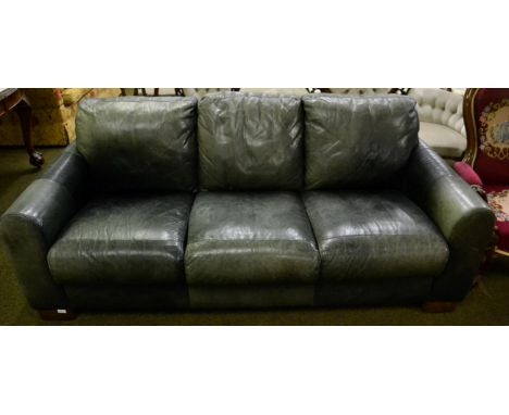 Sofa Italia: A three-seater settee, upholstered in vintage style green leather, with rounded arms, on walnut effect block fee