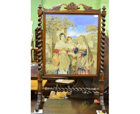 A Victorian rosewood framed needle work firescreen with boldly turned uprights and a twin barley twist stretcher