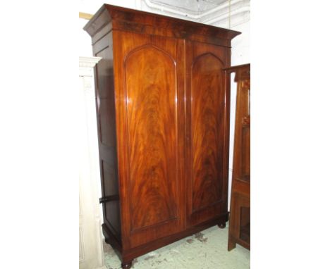 WARDROBE, 19th century Channel Islands flame mahogany with two panelled doors enclosing full height hanging space and a shelf