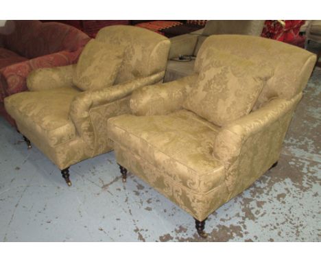 GEORGE SMITH ARMCHAIRS, a pair, in a light olive fabric floral design on turned castor supports each with a scatter cushion, 