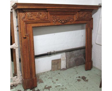 FIRE SURROUND, George III style pine and gesso with fruit garland and scrolling leaf decorated frieze, 151cm H x 183cm x 27cm