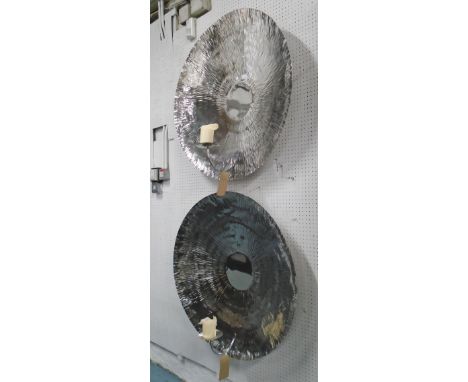 CANDLE SCONCES, a pair, consisting of two worked metal reflective light bowls with mounts for pillar candles in a polished me