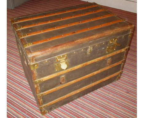 STEAMER TRUNK, early 20th century French canvas, beech, leather and brass bound with hinged top and fabric lined interior, 61