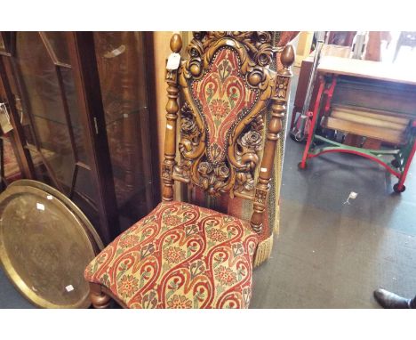 A good quality carved armorial chair having shield back with floral carving resting on carved supports and tapestry upholster