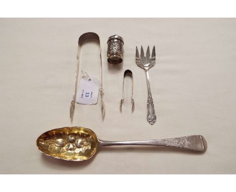 A London silver and gilt berry spoon, muffin fork, two pairs of silver tongs and an Eastern lidded pot