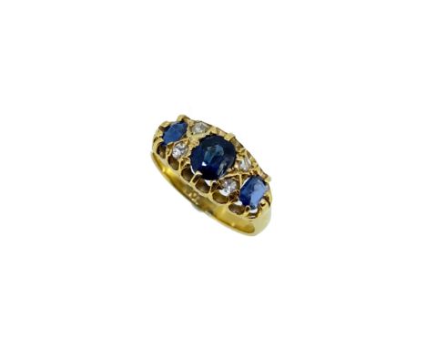 An early 20th century sapphire and diamond ring, claw set central oval faceted sapphire, 5.5 x 4.8mm, flanked by four rose, o