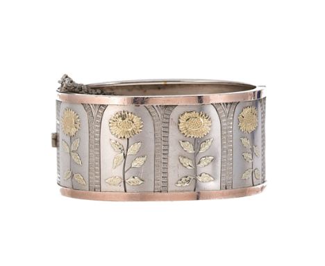 A floral cuff bangle, depicting four sunflowers, each in the centre of individual arches with a rose coloured border, inside 