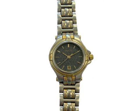 Gucci - A lady's two colour wristwatch, circa 1999, model 9045L, serial number 00561292, the signed circular graphite coloure