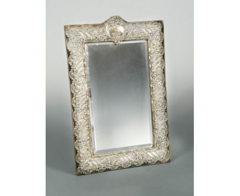 A Victorian silver mounted easel back dressing table mirror, mark of Henry Matthews, Birmingham 1900, the rectangular bevelle