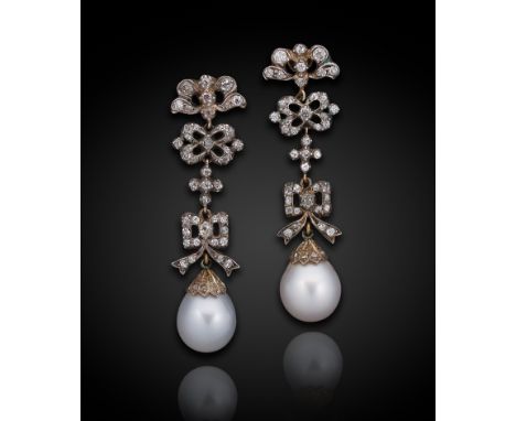 A pair of Edwardian pearl and diamond ear pendants, each with an articulated bow motif drop section, set with eighty eight ol