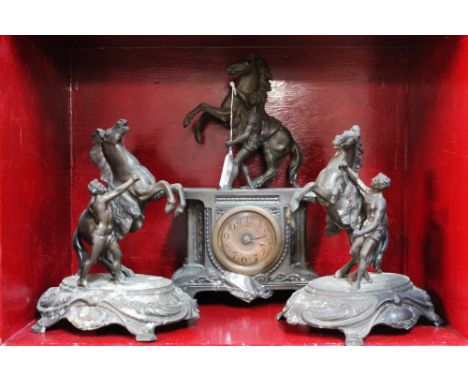 Metal mantel clock with rearing horse decor and pair of matching garnitures, clock 32 cm high