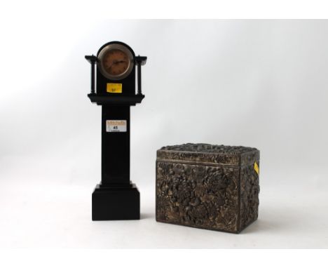 Metal floral patterned tea caddy and miniature ebony cased grandfather clock form clock, 31 cm high
