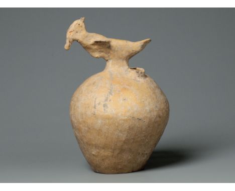 Height: 23.5cm, Length: 15cm with a truncated spout sitting on a flat base surmounted by a bird finial, wings outstretched an