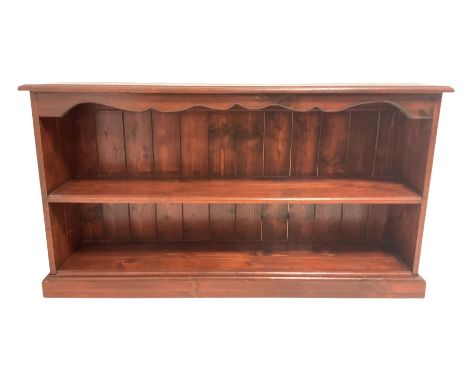 Stained pine low bookcase, moulded rectangular top over shaped frieze and shelf, plinth baseDimensions: Height:&nbsp;60cm&nbs