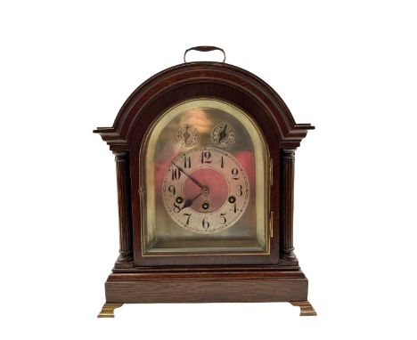 A German "Junghans" Westminster chiming mantle clock c1910, in an oak case with a break arch top and brass carrying handle, a