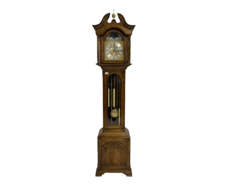 A late 20th century oak cased Grandmother clock with a swan's neck pediment and ball and spire finial, glazed break arch hood